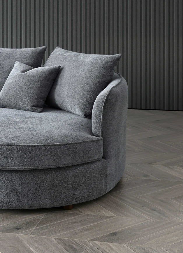 Luxury curved bouclé corner chaise sofa in Pebble and Charcoal with a sculptural organic design, deep cushions, and premium upholstery for modern UK living rooms.