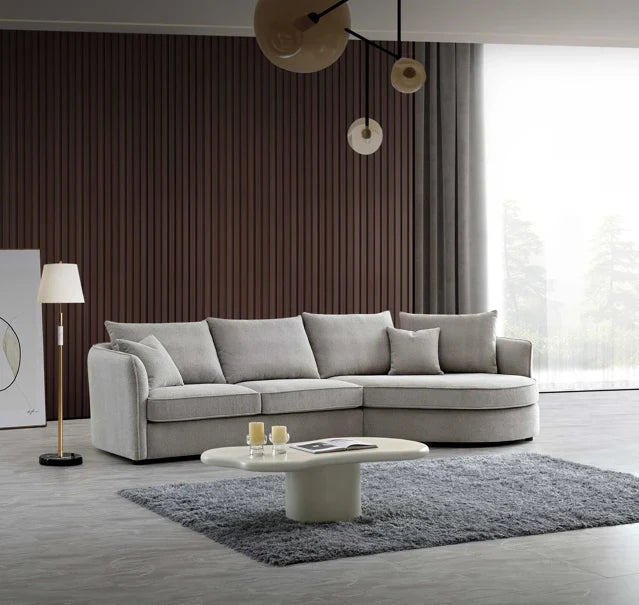 Luxury curved bouclé corner chaise sofa in Pebble and Charcoal with a sculptural organic design, deep cushions, and premium upholstery for modern UK living rooms.