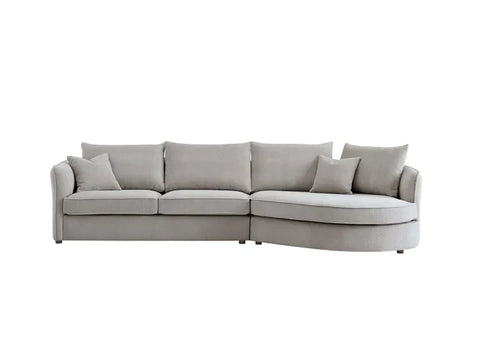 Luxury curved bouclé corner chaise sofa in Pebble and Charcoal with a sculptural organic design, deep cushions, and premium upholstery for modern UK living rooms.