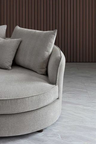 Luxury curved bouclé corner chaise sofa in Pebble and Charcoal with a sculptural organic design, deep cushions, and premium upholstery for modern UK living rooms.