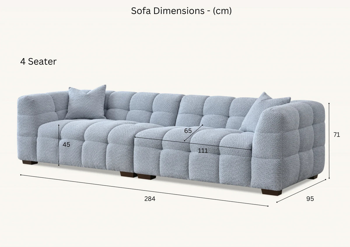 Tribeca oatmeal bouclé sofa with sculptural curved silhouette, deep channel stitching and contemporary designer styling for modern UK homes.