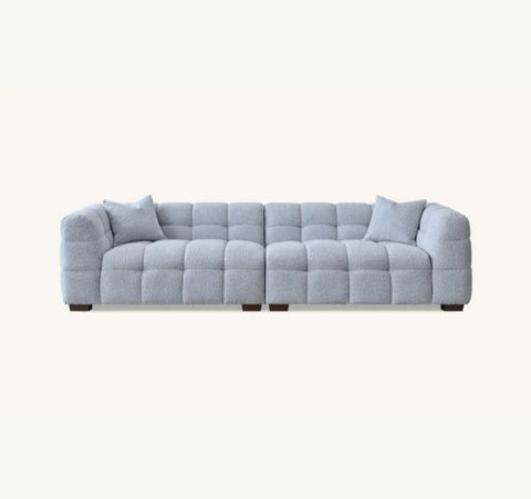 Luxury Tribeca Pearl Bouclé sofa featuring sculptural curved arms, deep channel stitching and contemporary designer styling for modern UK homes.