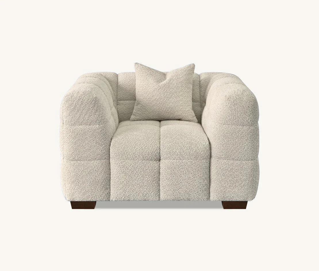 oatmeal bouclé sofa with sculptural curved silhouette, deep channel stitching, premium textured upholstery, and contemporary designer styling for modern UK homes.