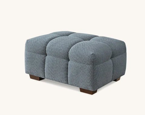 Bouclé corner sofa with chaise and matching footstool in iron grey, featuring a modern curved design for contemporary UK living rooms.
