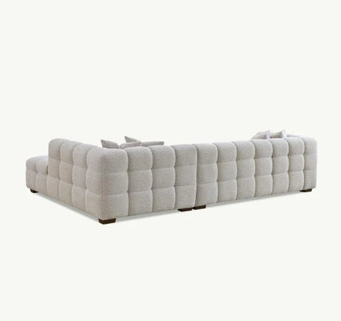 Luxury Tribeca oatmeal bouclé corner sofa with sculptural curved arms, deep channel stitching, premium textured and spacious L-shaped seating for modern UK homes.