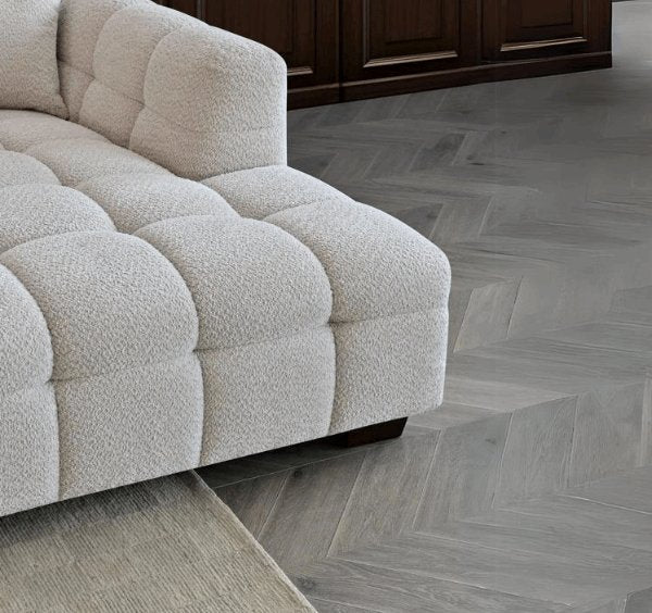 Tribeca oatmeal bouclé corner sofa with sculptural curved arms, deep channel stitching, premium textured upholstery, and spacious L-shaped seating for modern UK homes.