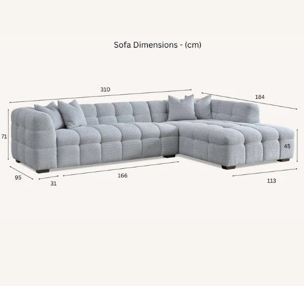 Luxury Tribeca oatmeal bouclé corner sofa with sculptural curved arms, deep channel stitching and spacious L-shaped seating for modern UK homes.