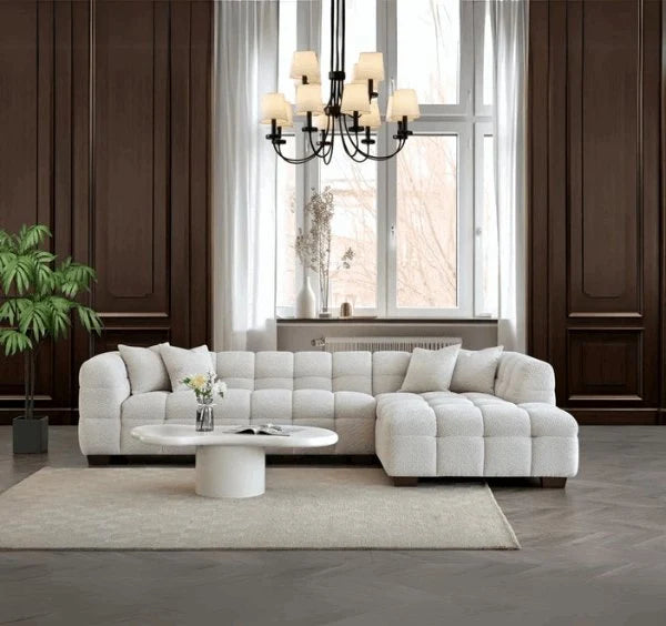 Luxury Tribeca oatmeal bouclé corner sofa with sculptural curved arms, deep channel stitching, premium textured upholstery, and spacious L-shaped seating for modern UK homes.