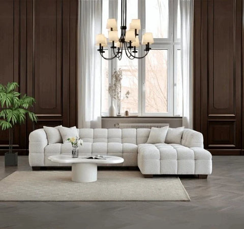 Luxury Tribeca oatmeal bouclé corner sofa with sculptural curved arms, deep channel stitching, premium textured upholstery, and spacious L-shaped seating for modern UK homes.